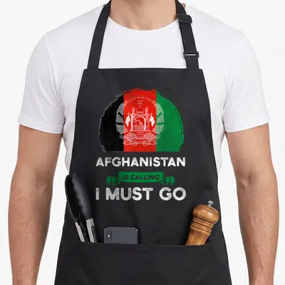 Afghanistan heritage aprons - Distressed circular Afghanistan flag in black red green white with text AFGHANISTAN IS — shown on a black cotton canvas apron against a white background