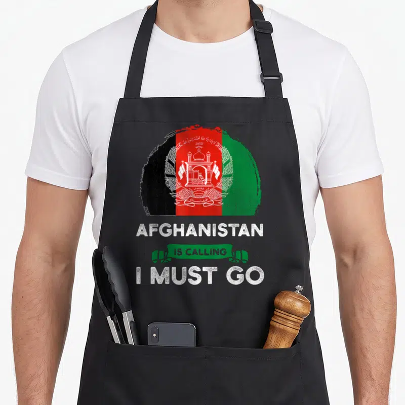 Afghanistan heritage aprons - Distressed circular Afghanistan flag in black red green white with text AFGHANISTAN IS — shown on a black cotton canvas apron against a white background
