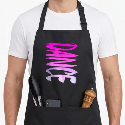 Dance colorful aprons - Vertical pink and purple brushstroke text reading Dance on a black background — shown on a black cotton canvas apron against a white background