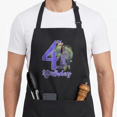 Wish asha birthday apron - Purple number 4 with Th Birthday text and a girl standing in nature — shown on a black cotton canvas apron against a white background