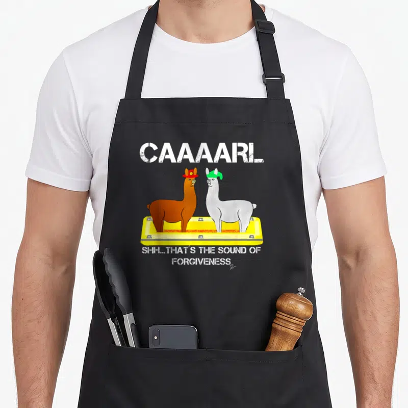 Lamas llama dad apron - Two llamas in yellow tray with CAAAARL and forgiveness text — shown on a black cotton canvas apron against a white background