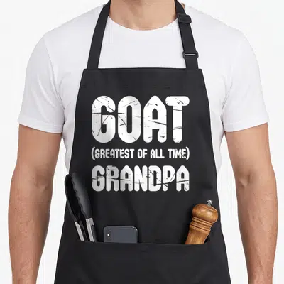 Goat greatest father day apron - White stacked text reading GOAT GREATEST OF ALL TIME GRANDPA — shown on a black cotton canvas apron against a white background