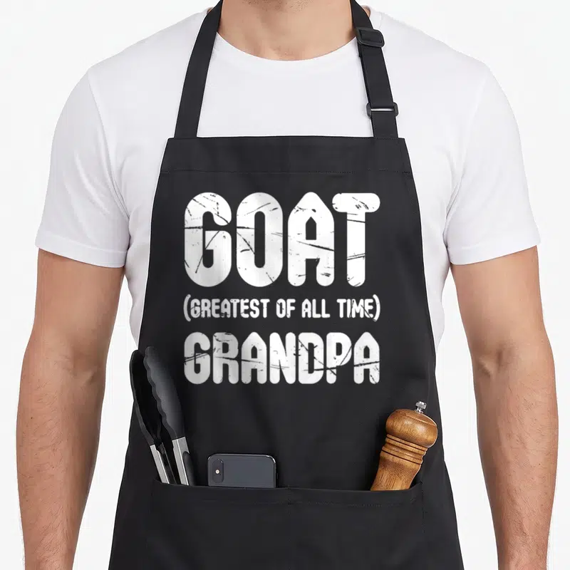 Goat greatest father day apron - White stacked text reading GOAT GREATEST OF ALL TIME GRANDPA — shown on a black cotton canvas apron against a white background