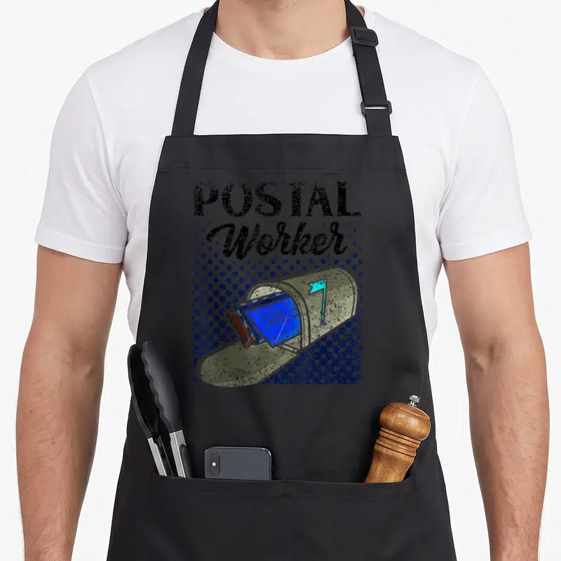 Mailman mail postman postal aprons - Retro mailbox with blue letters and black POSTAL Worker text on blue halftone — shown on a black cotton canvas apron against a white background