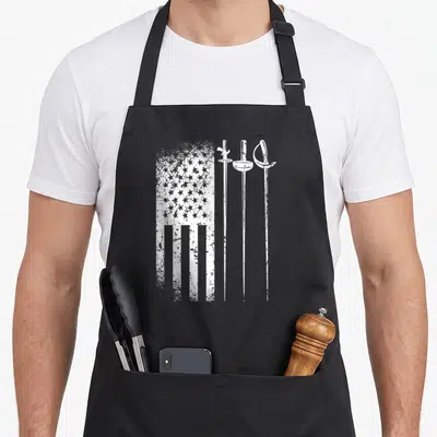 Patriotic fencing apron - Distressed white USA flag next to three vertical fencing swords on canvas — shown on a black cotton canvas apron against a white background