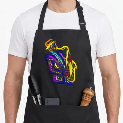Saxophonist jazz apron - Abstract colorful brushstrokes forming a man playing a saxophone in blue, yellow, purple — shown on a black cotton canvas apron against a white background