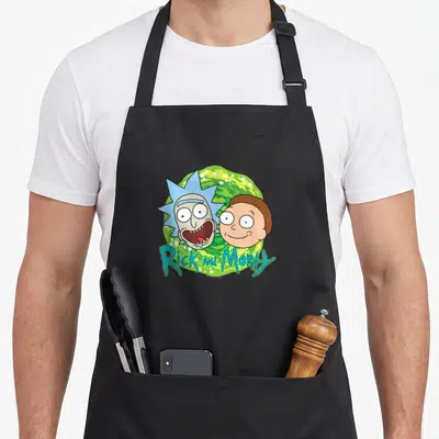 Portal face apron - Rick and Morty heads over green swirling portal with dripping blue text — shown on a black cotton canvas apron against a white background