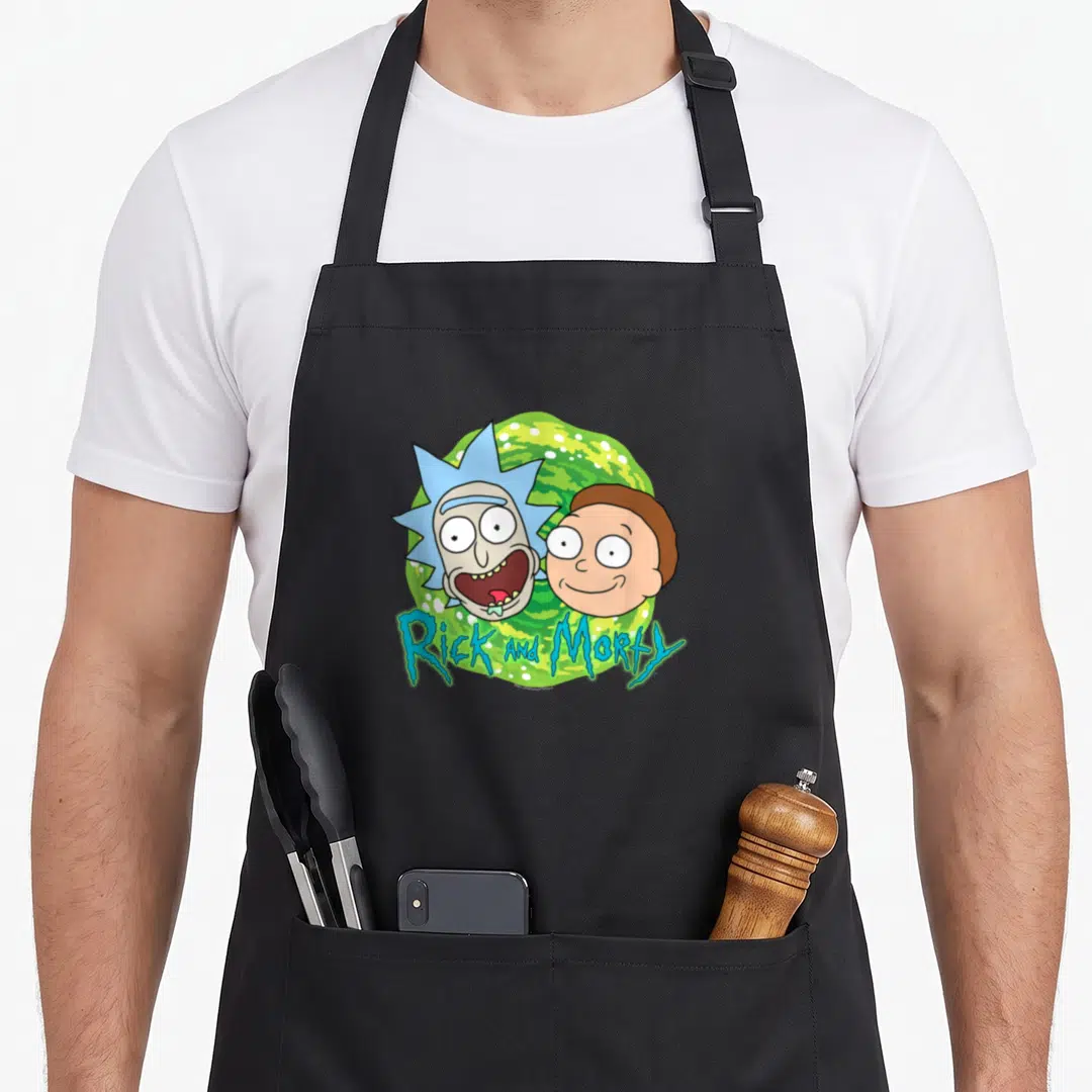 Portal face apron - Rick and Morty heads over green swirling portal with dripping blue text — shown on a black cotton canvas apron against a white background