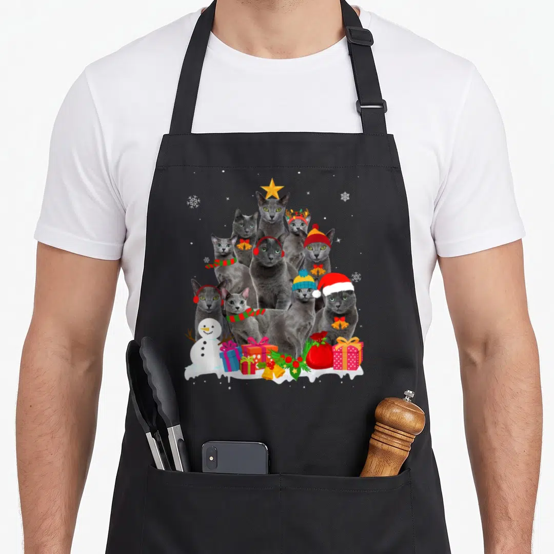 Tree russian aprons - Nine grey cats in a pyramid shape with a snowman and Christmas gifts on white snow — shown on a black cotton canvas apron against a white background