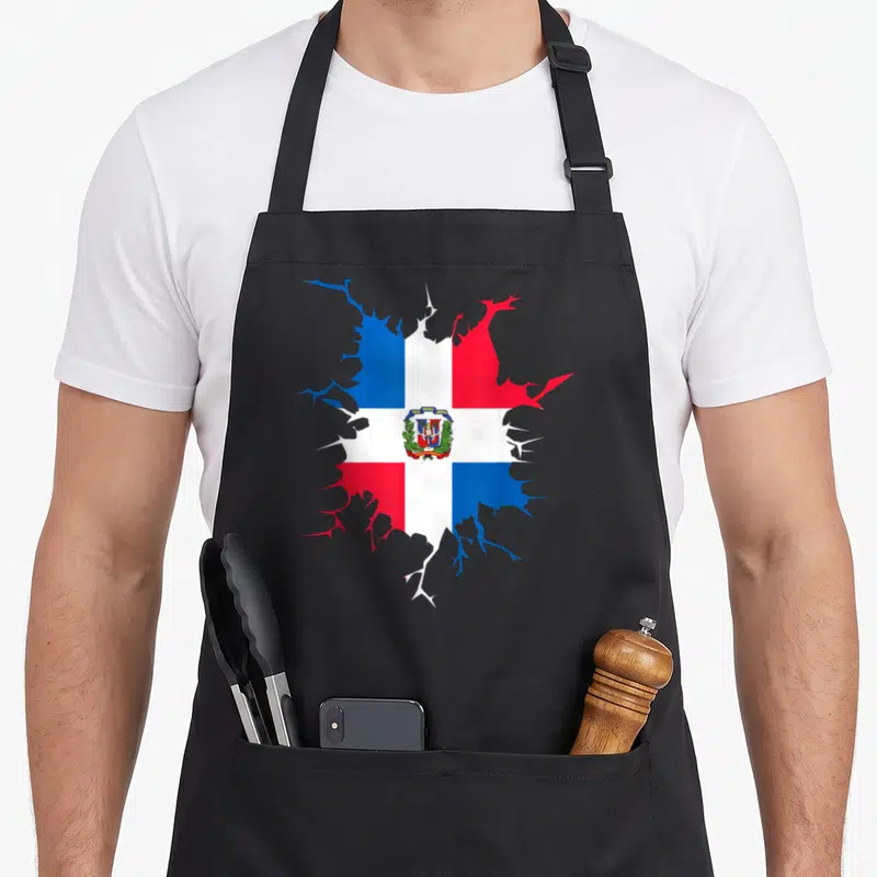 Inside pride apron - Dominican Republic flag shaped like a cracked hole with a coat of arms in red, white, and blue — shown on a black cotton canvas apron against a white background