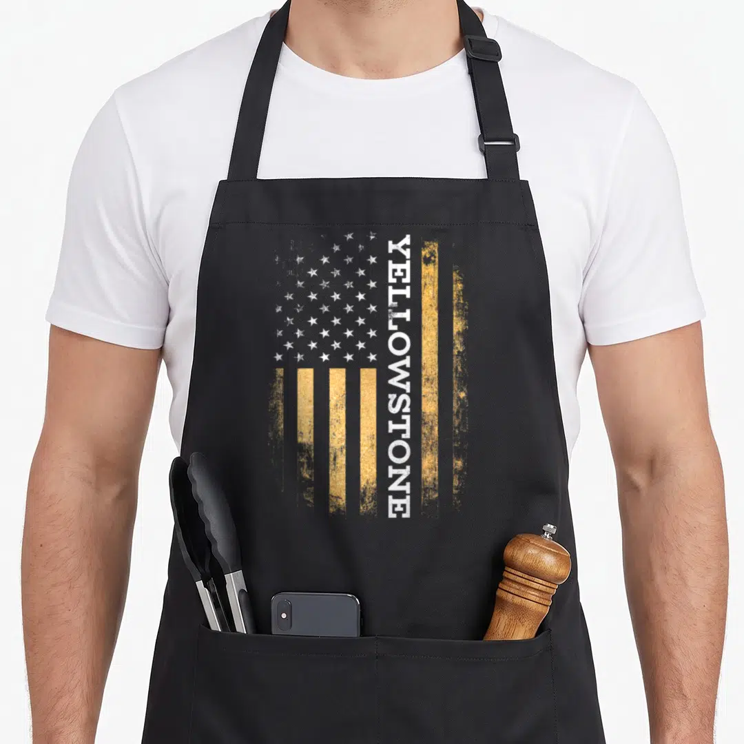 Funny stone apron - Distressed yellow and white flag with vertical Yellowstone text — shown on a black cotton canvas apron against a white background