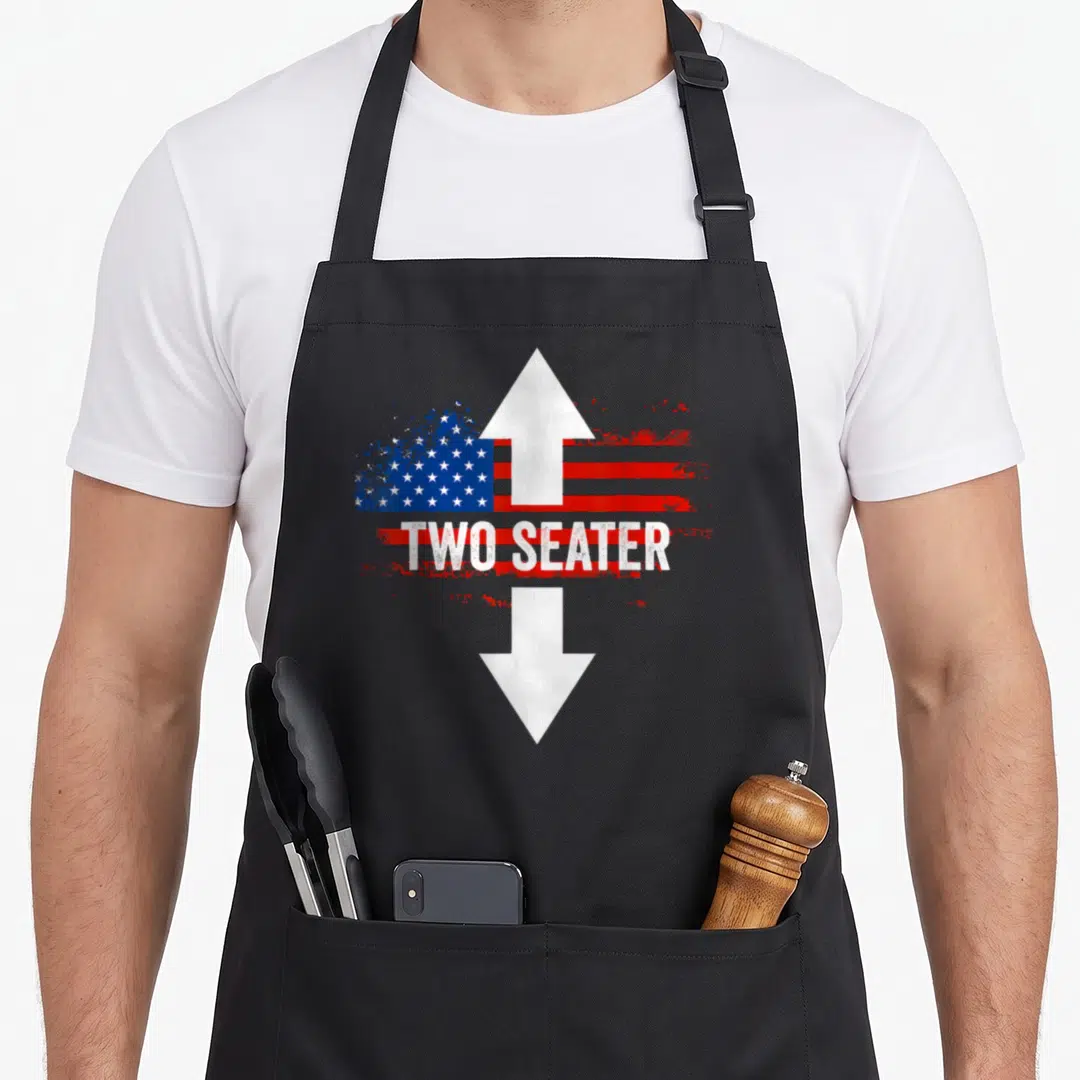 4th the dirty apron - Distressed US flag with white double arrow and white text reading TWO SEATER — shown on a black cotton canvas apron against a white background