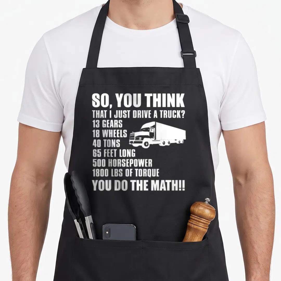 Math truck apron - White stacked text listing truck specs next to a semi-truck silhouette — shown on a black cotton canvas apron against a white background