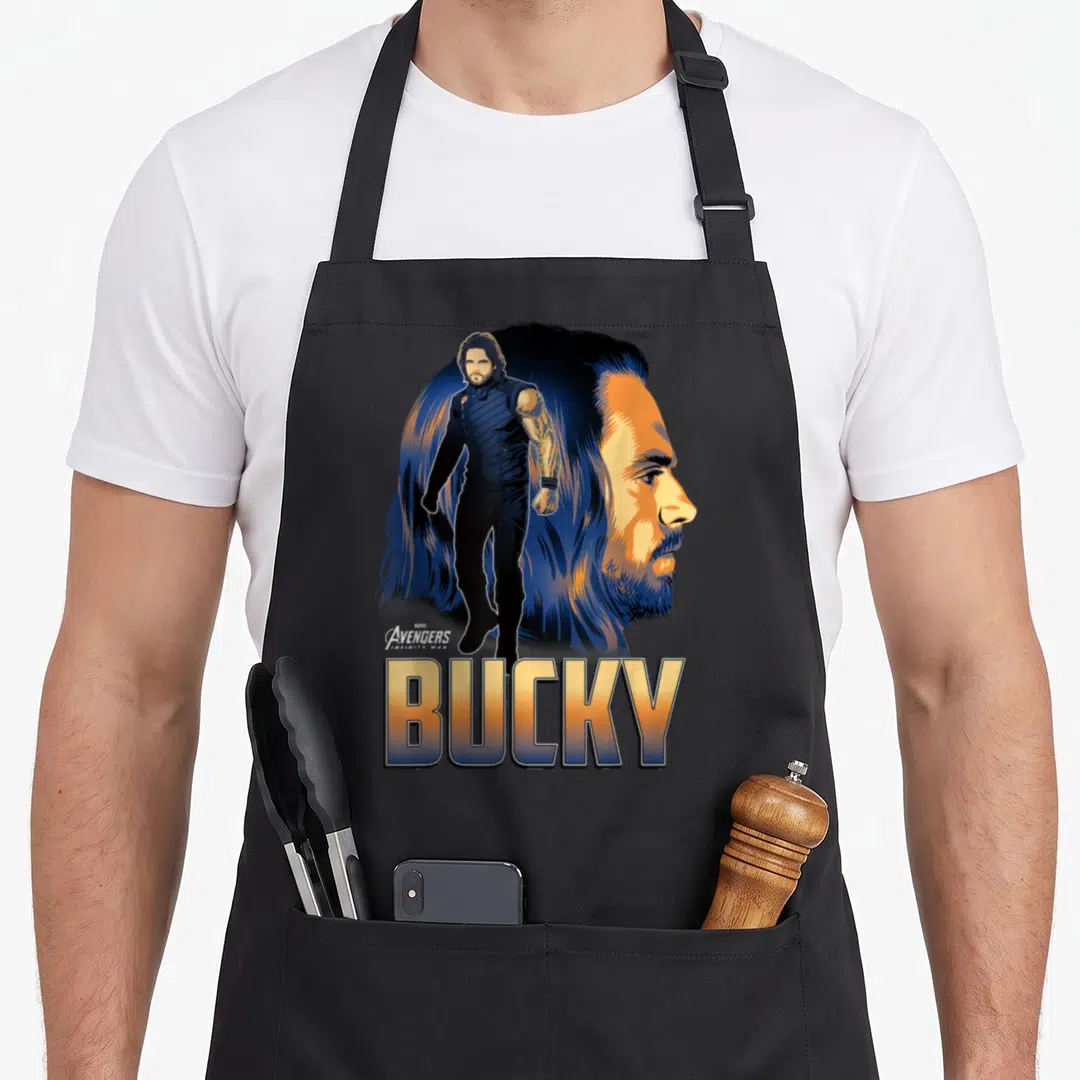 Bucky infinity apron - Bucky Barnes full body standing before large profile head with stacked text — shown on a black cotton canvas apron against a white background