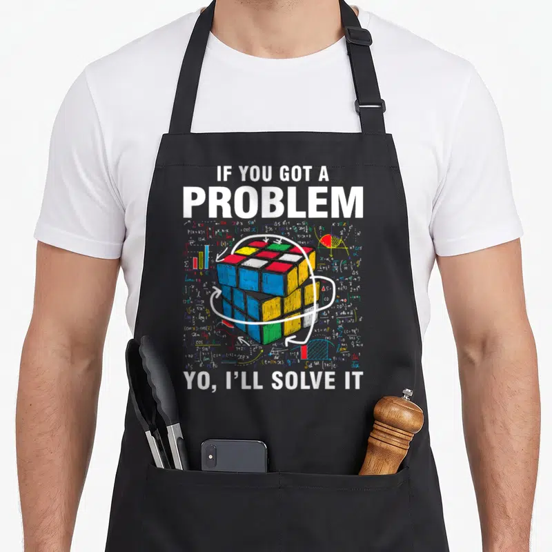 Problem speed girl apron - Rubik's cube surrounded by math formulas with text IF YOU GOT A PROBLEM — shown on a black cotton canvas apron against a white background