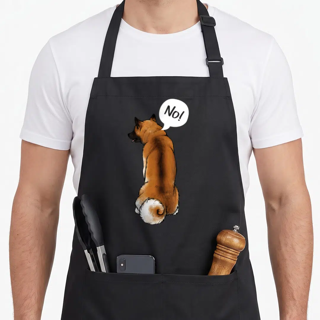 Breeder dog apron - Cartoon brown and white dog facing away with white speech bubble reading No! — shown on a black cotton canvas apron against a white background