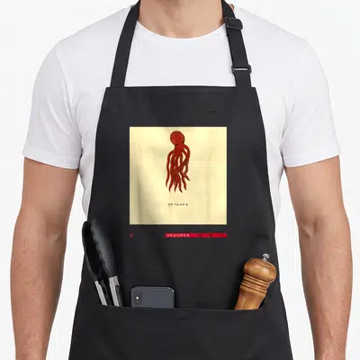 Studio david aprons - Red octopus illustration with spaced black text on cream background — shown on a black cotton canvas apron against a white background