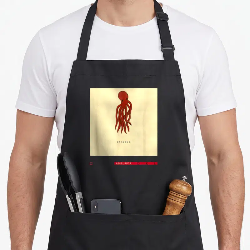 Studio david aprons - Red octopus illustration with spaced black text on cream background — shown on a black cotton canvas apron against a white background
