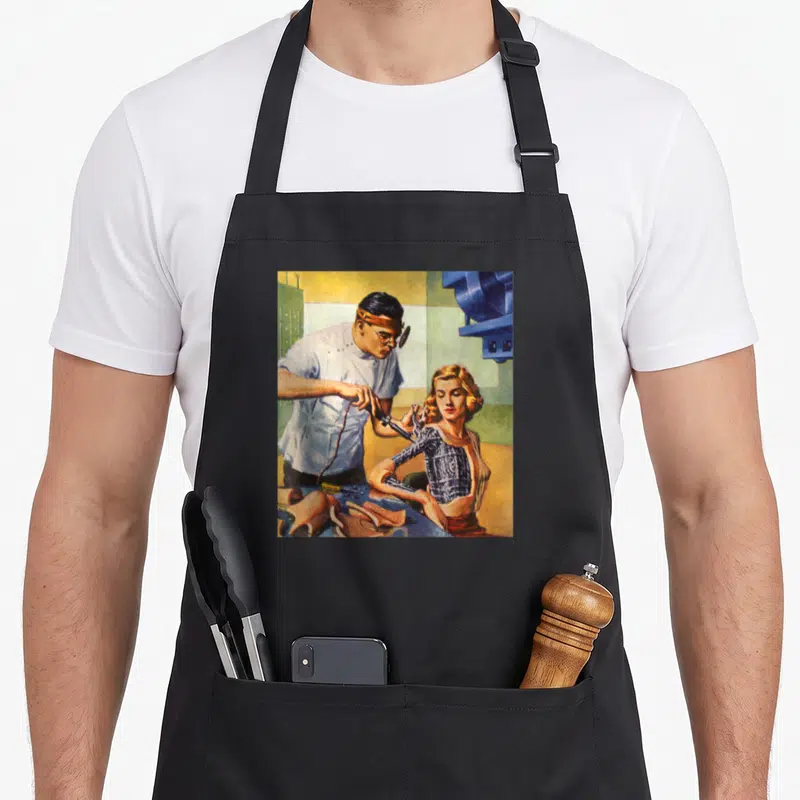 Sci science apron - Retro illustration of a man repairing a bionic woman's arm near blue machinery — shown on a black cotton canvas apron against a white background