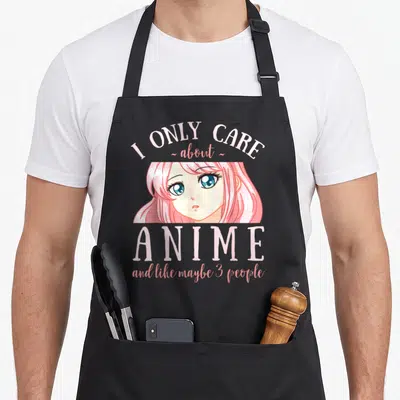 Maybe anime apron - Pink and white anime girl face with text I ONLY CARE about ANIME and like maybe 3 people — shown on a black cotton canvas apron against a white background