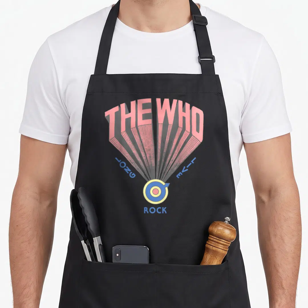 Live rock apron - Pink radiating lines connect THE WHO text to a blue and yellow target symbol with ROCK below — shown on a black cotton canvas apron against a white background