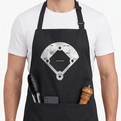 Funny distressed baseball apron - White baseball diamond with text Tomorrow Why Because I Don't Give A Barn What I — shown on a black cotton canvas apron against a white background