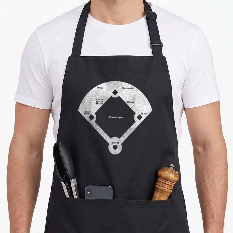 Funny distressed baseball apron - White baseball diamond with text Tomorrow Why Because I Don't Give A Barn What I — shown on a black cotton canvas apron against a white background