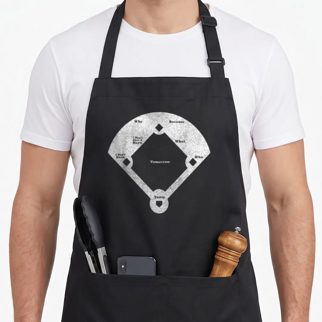 Funny distressed baseball apron - White baseball diamond with text Tomorrow Why Because I Don't Give A Barn What I — shown on a black cotton canvas apron against a white background