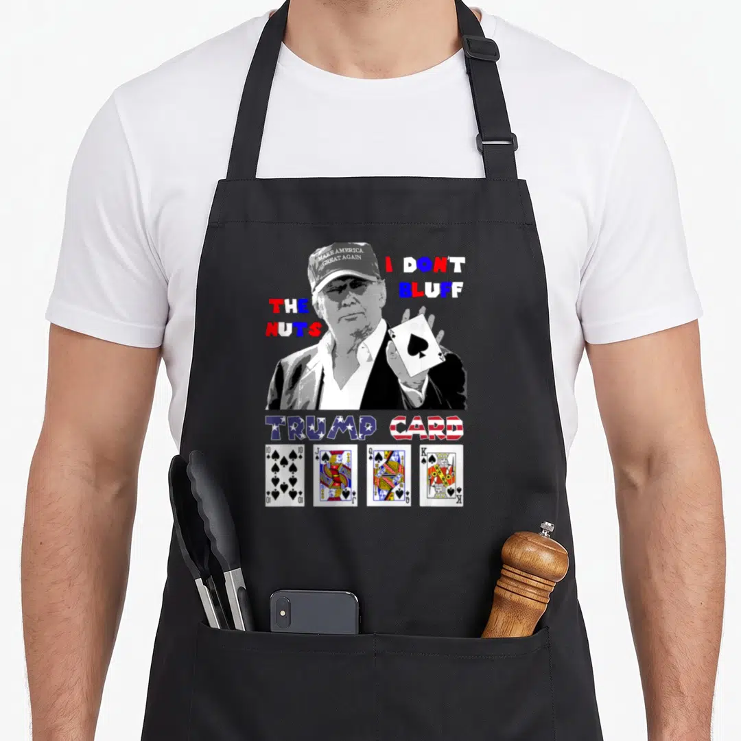 Trump ace apron - Poker player holding Ace of Spades with text I DON'T BLUFF THE NUTS and Trump Card lettering — shown on a black cotton canvas apron against a white background