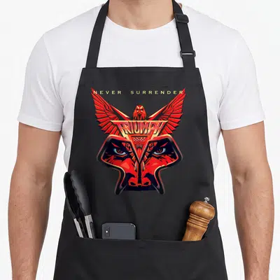 Surrender manic llc apron - Red eagle head with spread wings, gold TRIUMPH banner, and NEVER SURRENDER text — shown on a black cotton canvas apron against a white background