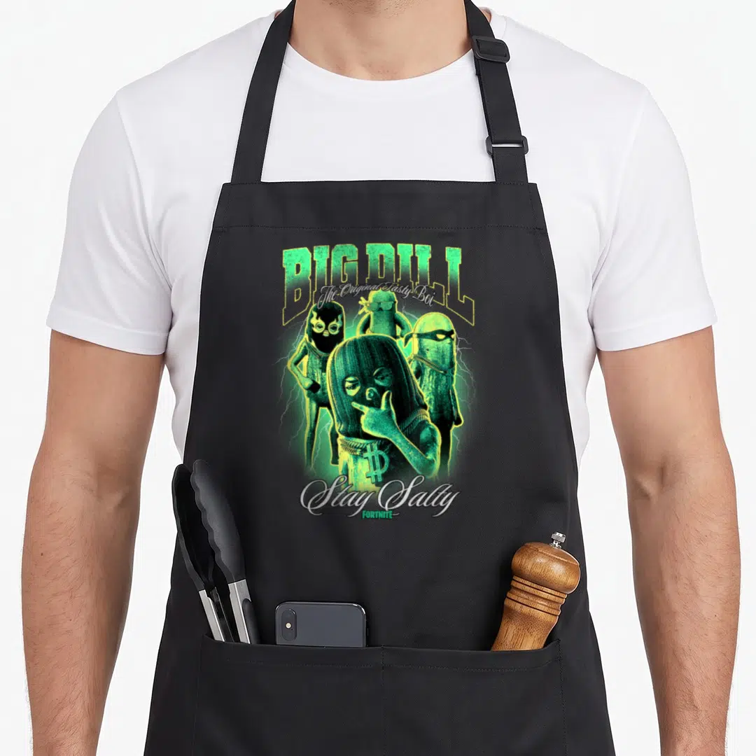 Dill tasty aprons - Four masked pickle characters with lightning and BIG DILL text in green and yellow — shown on a black cotton canvas apron against a white background