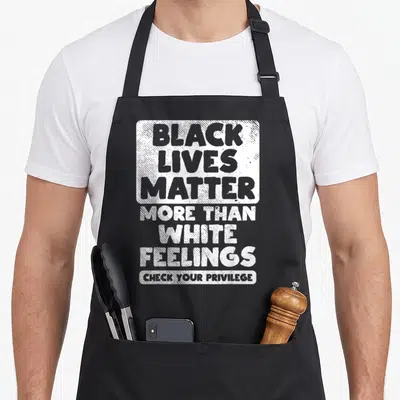 Live african apron - White stacked text reading Black Lives Matter More Than White Feelings Check Your Privilege — shown on a black cotton canvas apron against a white background