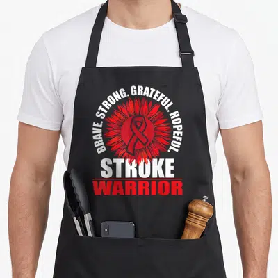 Stroke warrior ribbon apron - Red sunflower with awareness ribbon and text Brave Strong Grateful Hopeful Stroke Warrior — shown on a black cotton canvas apron against a white background