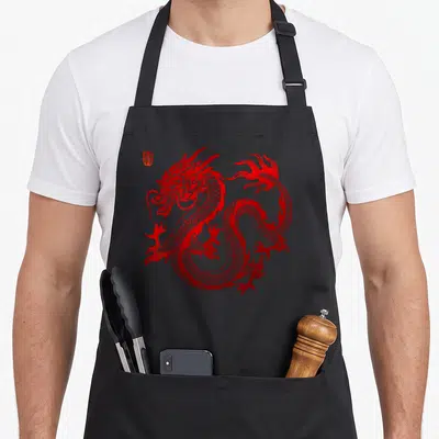 Chinese dragon apron for women - Red coiled dragon line art with kanji character in top left corner — shown on a black cotton canvas apron against a white background