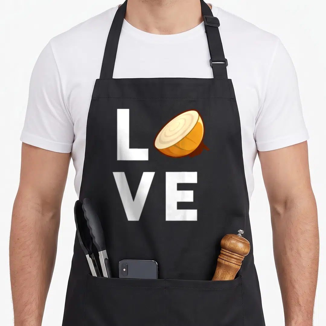Onion food aprons - White LVE text with sliced onion replacing O, beige and brown details — shown on a black cotton canvas apron against a white background