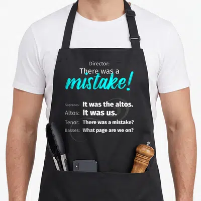 Singing choir apron - Choir dialogue text and large treble clef in white, cyan, and grey on dark background — shown on a black cotton canvas apron against a white background