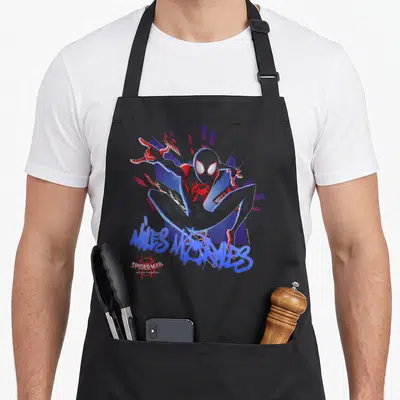 Graffiti spider apron - Miles Morales cartoon figure with blue graffiti script and red geometric shapes — shown on a black cotton canvas apron against a white background