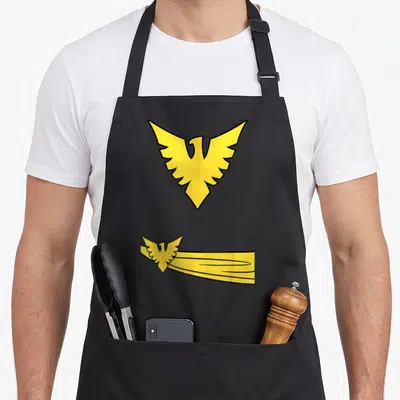 Comic jean apron - Two stacked yellow cartoon phoenixes, top standalone, bottom with trailing lines to the right — shown on a black cotton canvas apron against a white background