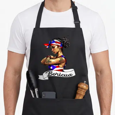 Mujer pride apron - Boricua woman with arms crossed wearing red white blue flag bandana and top — shown on a black cotton canvas apron against a white background