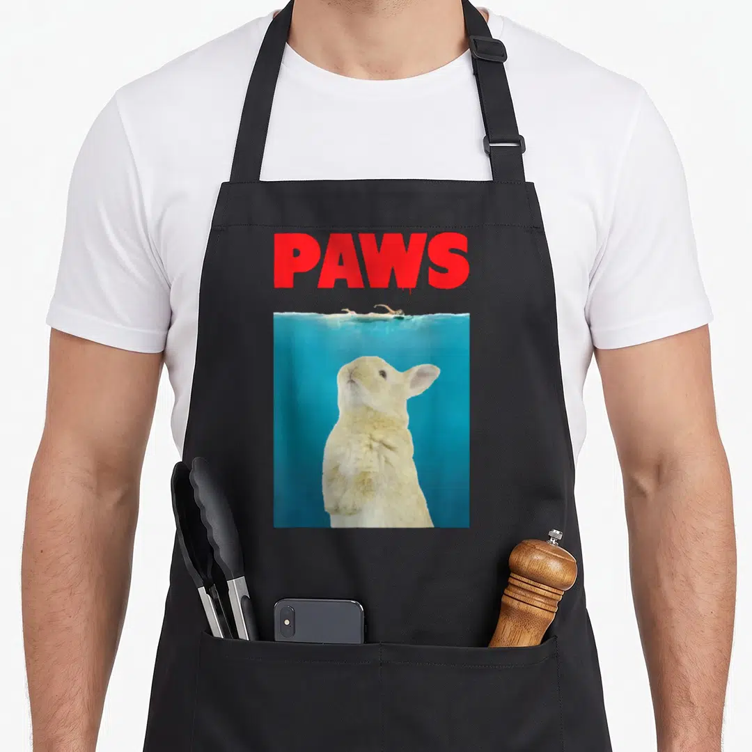 Paw bunny apron - Red PAWS text above rabbit underwater and swimmer photo — shown on a black cotton canvas apron against a white background