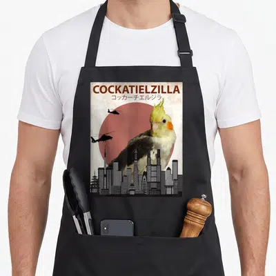 Cockatoo cockatiel lover apron - Giant cockatiel looms over black city skyline with red sun and two helicopters flying — shown on a black cotton canvas apron against a white background