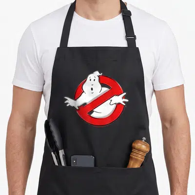 Movie fan lover apron - White cartoon ghost behind red prohibition circle on black bib — shown on a black cotton canvas apron against a white background