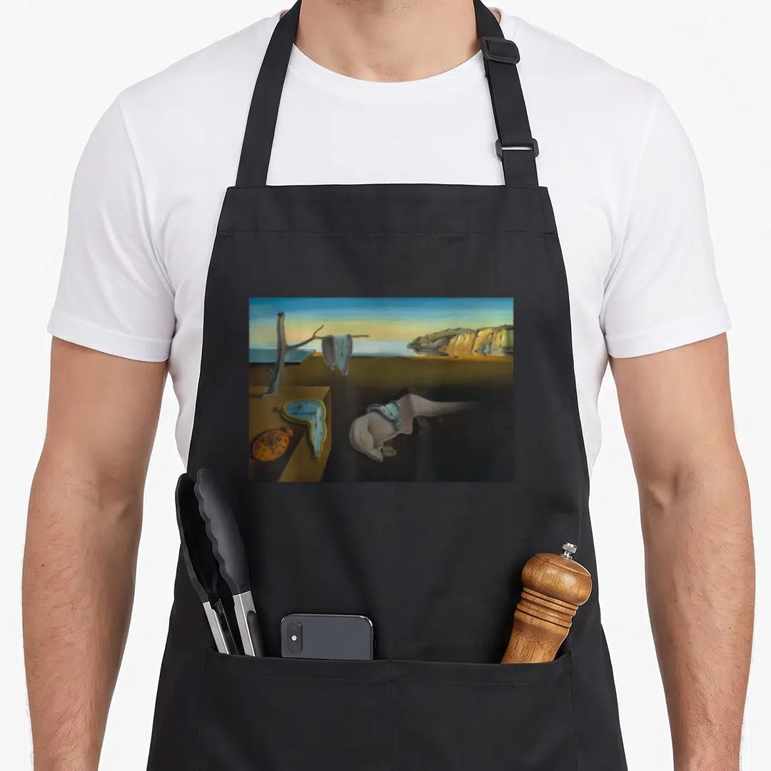 Persistence memory apron - Surreal melting clocks in blue and yellow on brown ground with ants on orange watch face — shown on a black cotton canvas apron against a white background