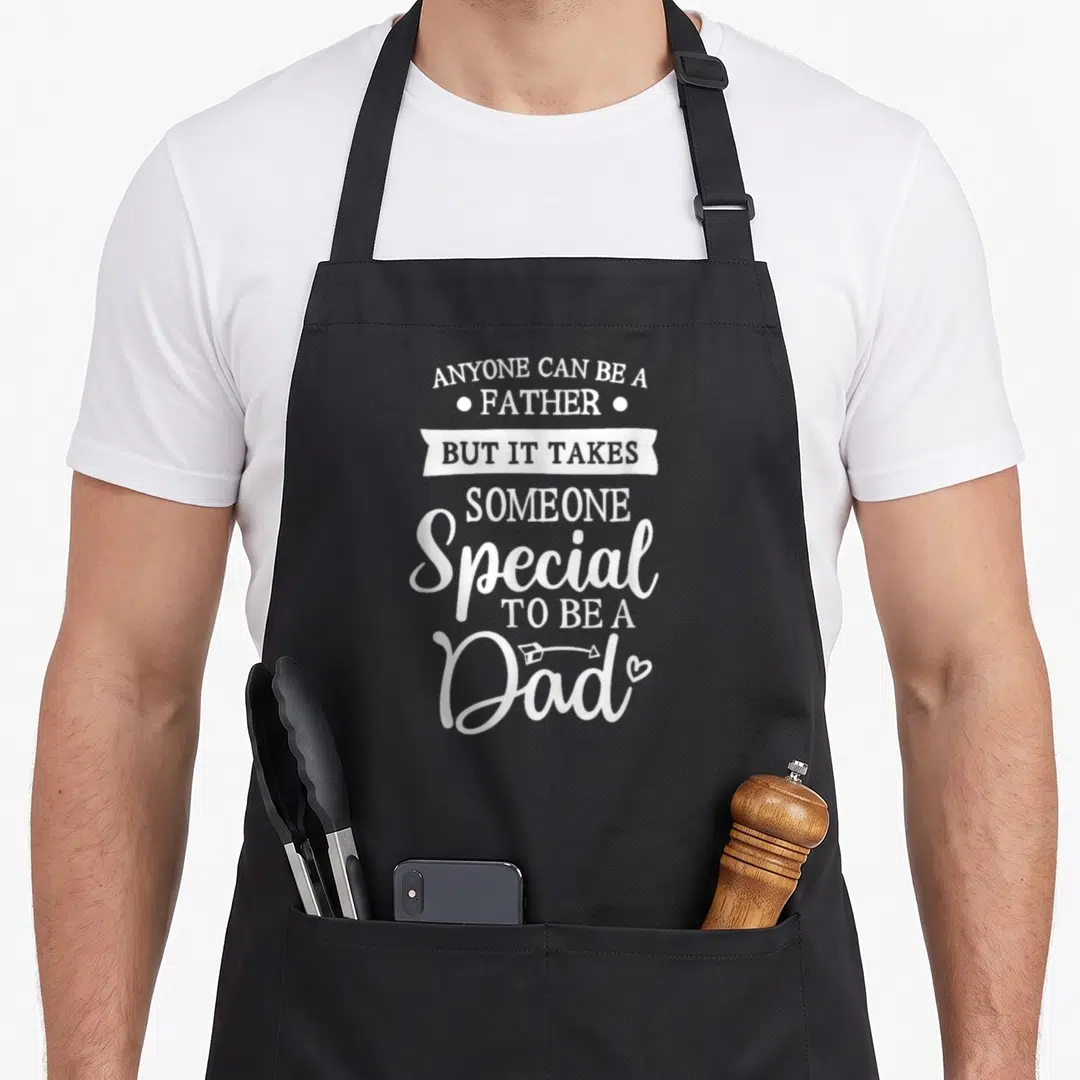 Anyone special aprons - White stacked typography quote about being a special dad with dots banner and arrow heart — shown on a black cotton canvas apron against a white background
