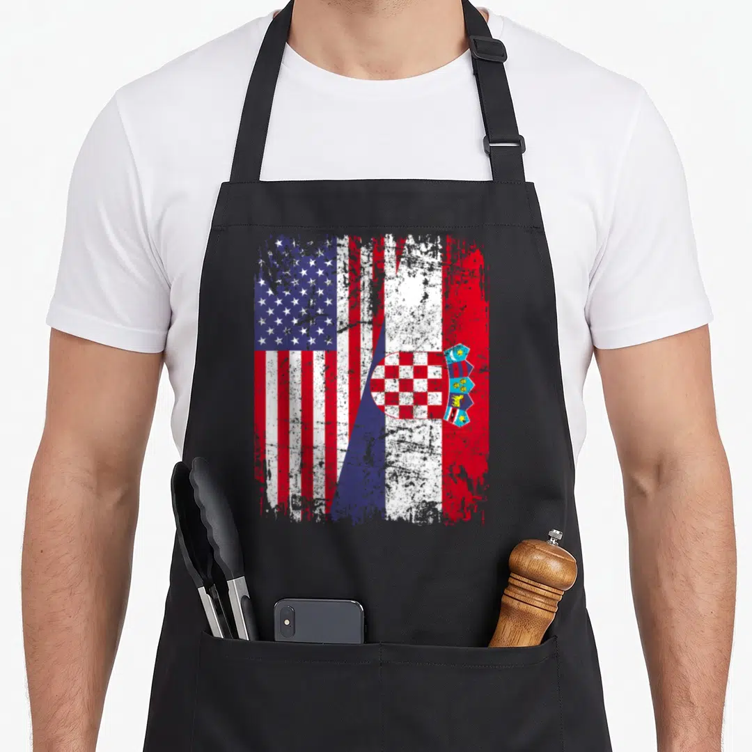 Root flag croatian aprons - Distressed red white and blue flags merged diagonally with checkerboard shield — shown on a black cotton canvas apron against a white background
