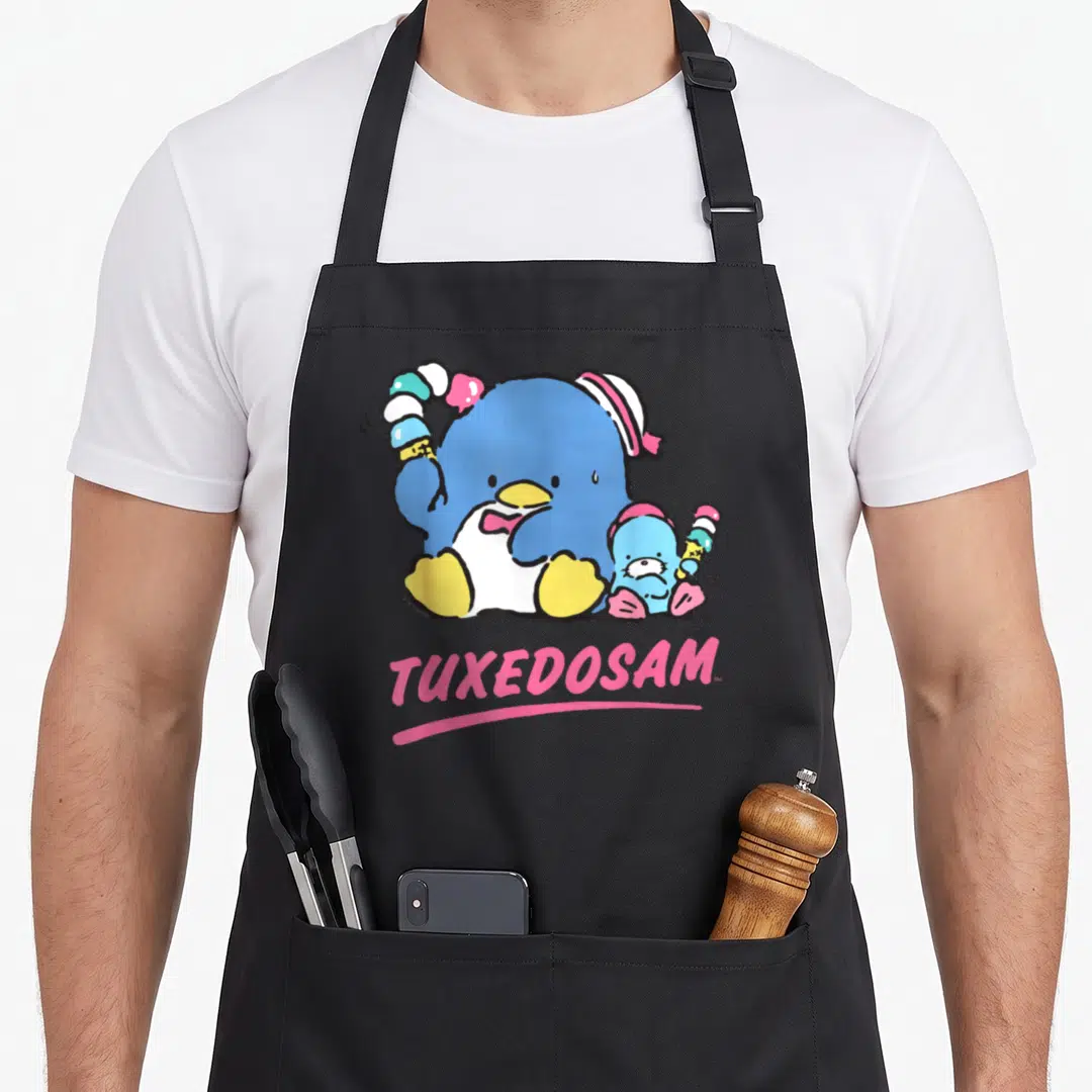 Tuxedosam ice cream apron - Two blue penguins holding ice cream with pink TUXEDOSAM text below — shown on a black cotton canvas apron against a white background