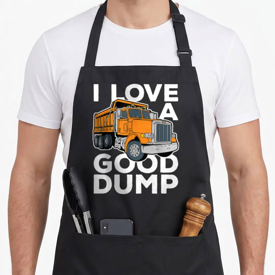 Driver dump truck apron - Orange cartoon dump truck with I Love a Good Dump text in white letters — shown on a black cotton canvas apron against a white background
