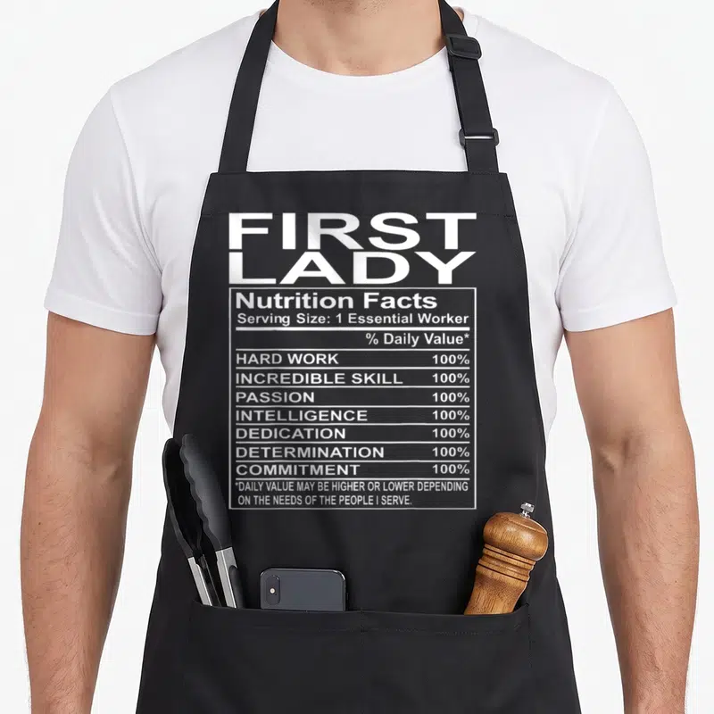 Appreciation church aprons - First Lady nutrition facts label with white text listing hard work and dedication — shown on a black cotton canvas apron against a white background