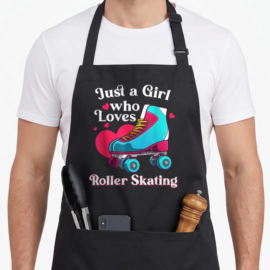 Skating birthday for kids roller skates apron - Cartoon blue roller skate over pink heart with white text Just a Girl — shown on a black cotton canvas apron against a white background