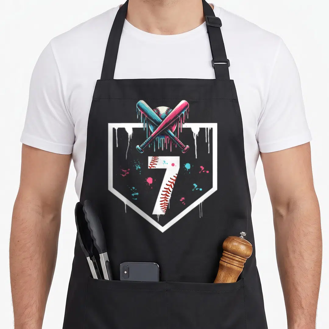 Plate birthday apron - Number 7 inside home plate with two crossed dripping bats and baseball — shown on a black cotton canvas apron against a white background
